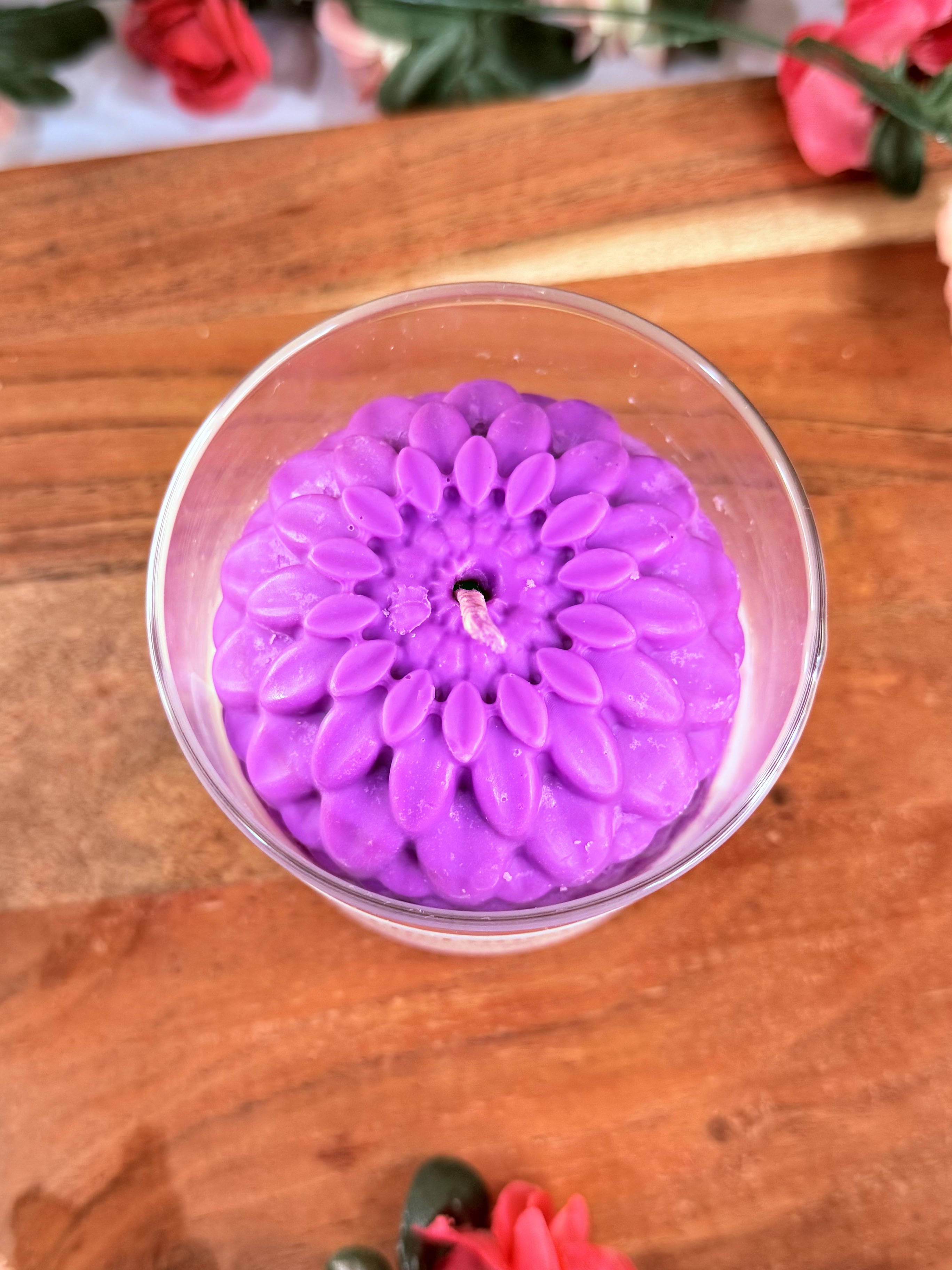 A candle with a purple flower top.
